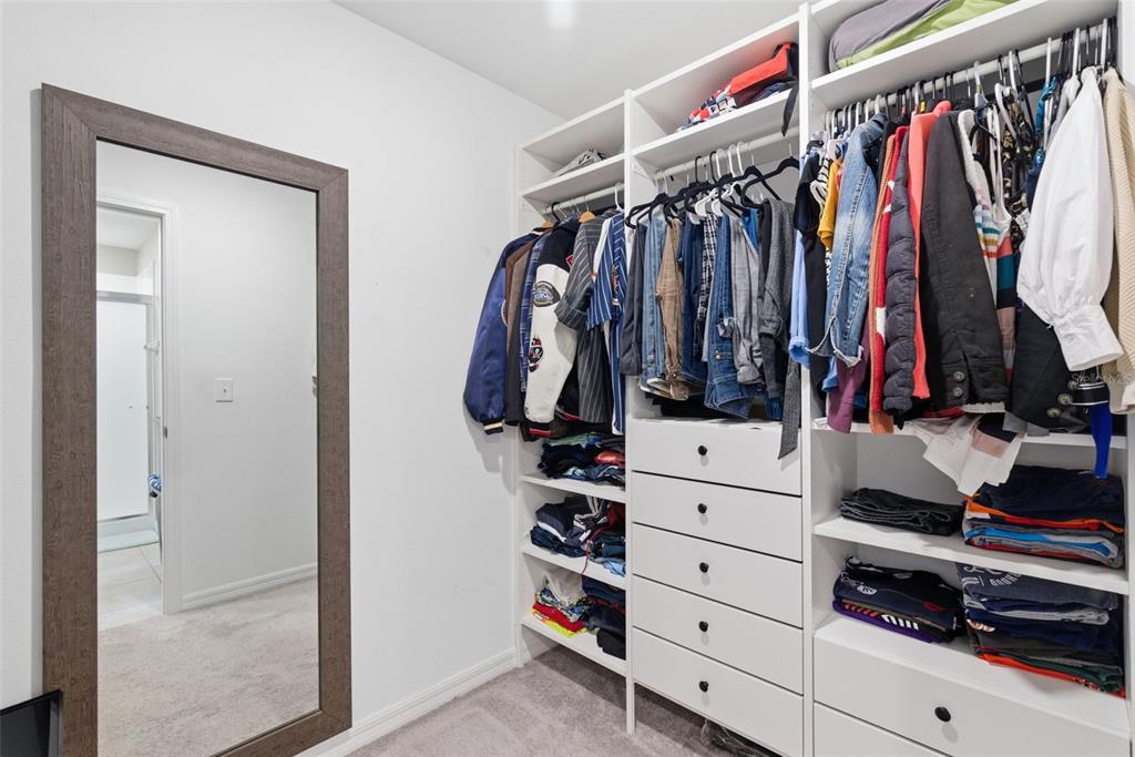 10239 Bright Crystal Avenue Riverview, FL 33578 - Photo 41 of 47 a view of walk in closet with clothes