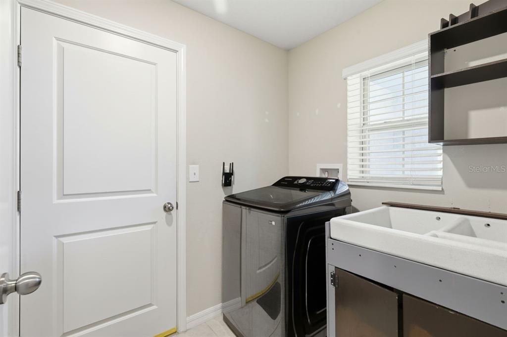 10239 Bright Crystal Avenue Riverview, FL 33578 - Photo 47 of 47 a view of a sink and a window in a room