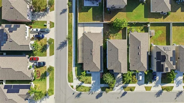 a aerial view of multi story residential apartment building with yard