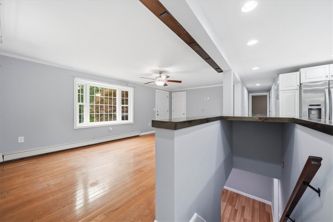 214 Anan Wade Road Glocester, RI 02857 - Photo 12 of 50 Bright and spacious living room with gleaming hardwood floors, abundant natural light and an open connection to the kitchen.