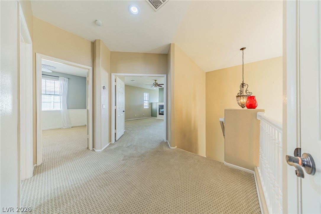 2504 Putting Green Drive Henderson, NV 89074 - Photo 37 of 56 This upper landing offers cozy carpeting and leads to inviting living spaces.