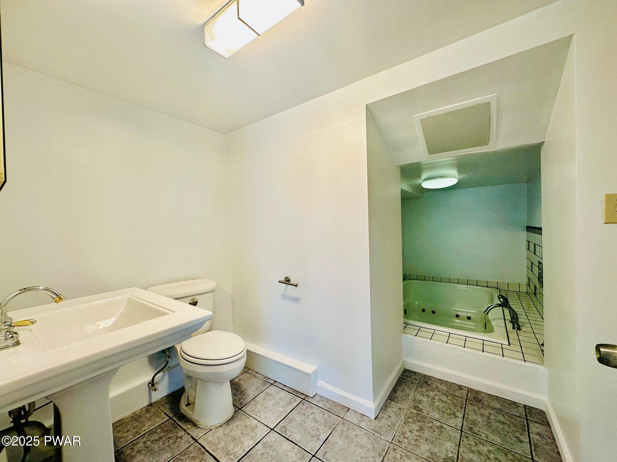191 Hemlock Grove Road Greentown, PA 18426 - Photo 14 of 31 a bathroom with a granite countertop toilet and a sink
