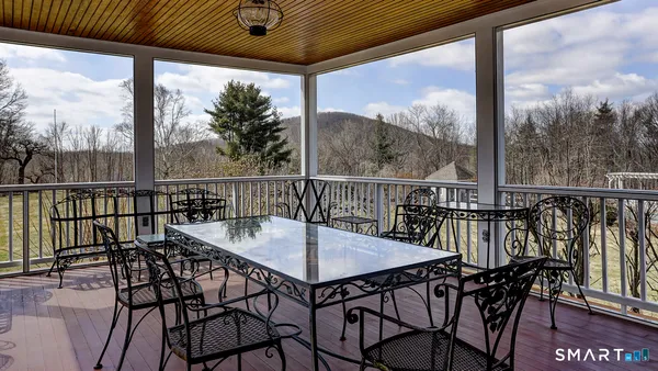a view of a chairs and table in the balcony