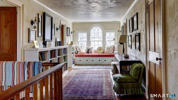 a living room with lots of furniture and a book shelf