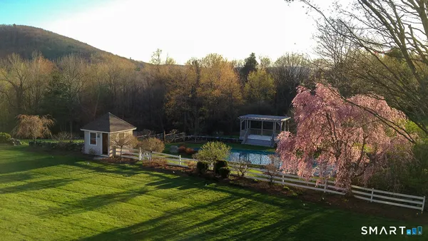 a backyard of a house with table and chairs