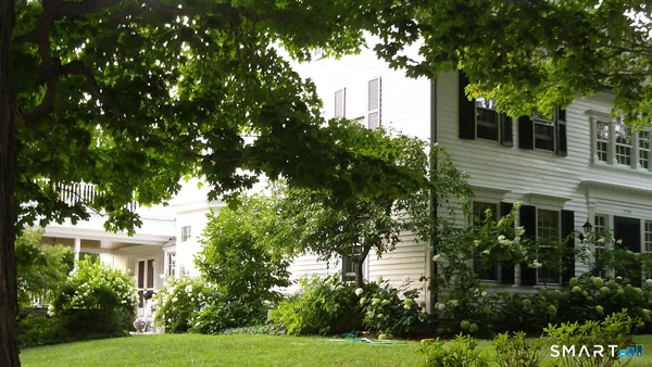 a front view of a house with garden