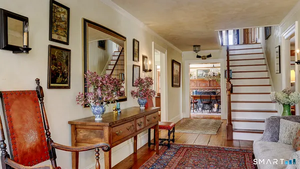 a living room with furniture a rug and a window