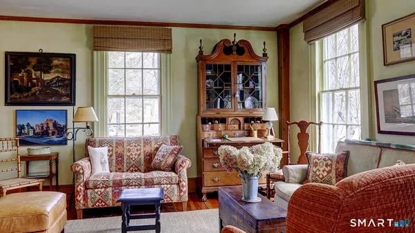 a living room with furniture a rug and a window