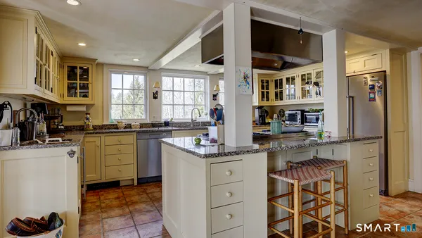 a kitchen with stainless steel appliances granite countertop a stove and a sink