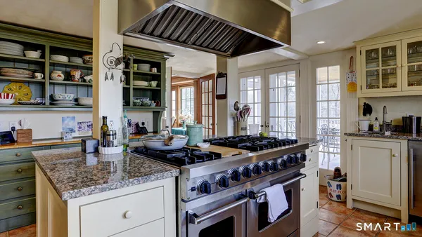 a kitchen with stainless steel appliances granite countertop a stove and a sink