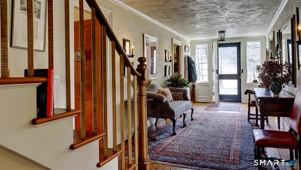 a view of a livingroom with furniture window and wooden floor