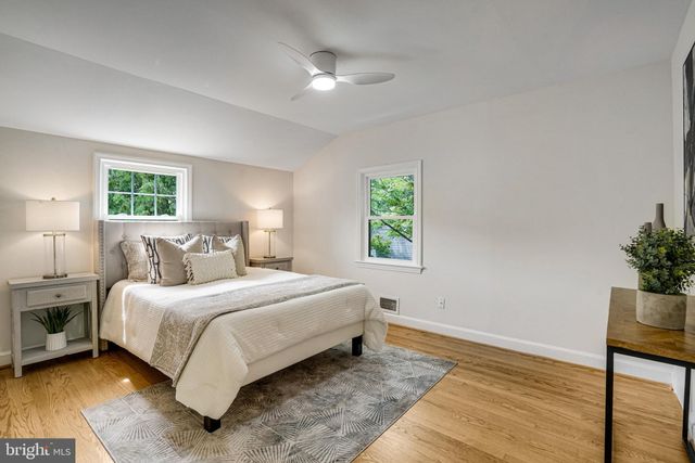 a bedroom with a bed and a potted plant