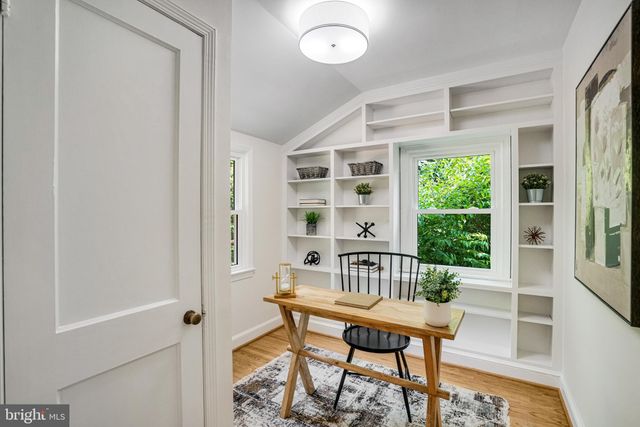 a view of a room with a table and chairs