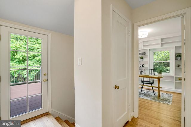 a view of a livingroom with wooden floor and furniture