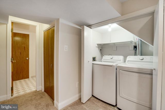 a view of storage and utility room with washer and dryer