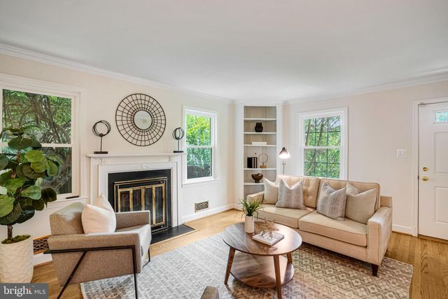 a living room with furniture a window and a fireplace
