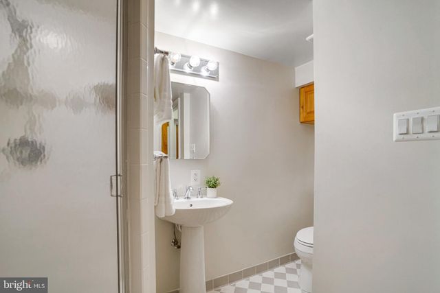 a bathroom with a sink a toilet and mirror