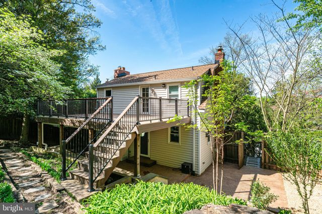 a view of a house with a small yard and wooden fence