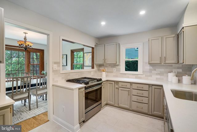 a kitchen with a stove sink and cabinets