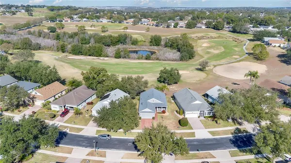 an aerial view of residential houses with outdoor space and river view