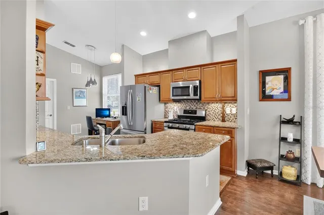 a living room with dining table and a refrigerator