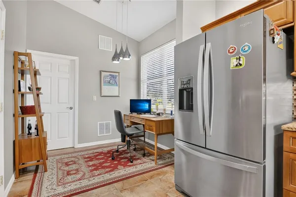 a kitchen with stainless steel appliances granite countertop a refrigerator and a sink