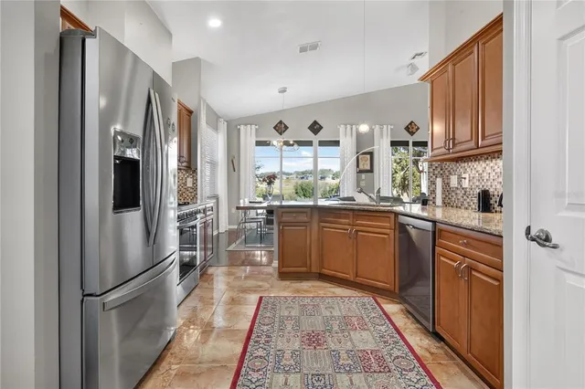 a living room with furniture chandelier and a mirror