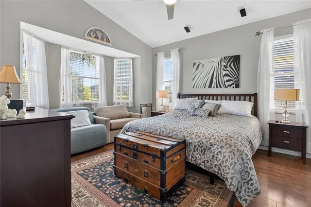 a bedroom with a large bed and a window