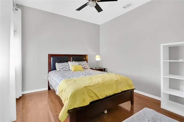a bathroom with a toilet sink vanity and shower