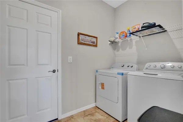 a view of a dining room with furniture a rug and a large mirror
