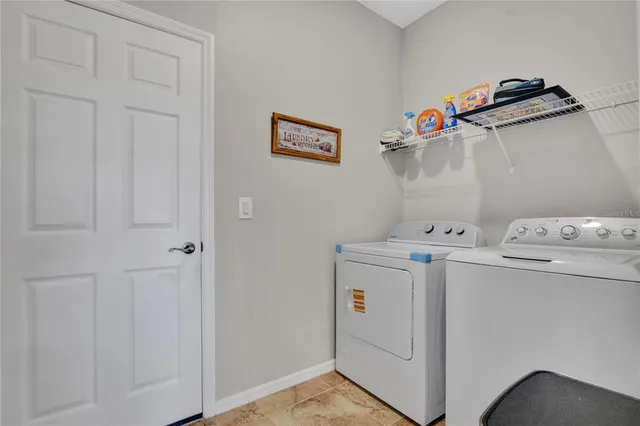 a view of a dining room with furniture a rug and a large mirror