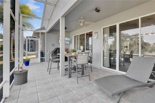 a dining room with furniture and a floor to ceiling window