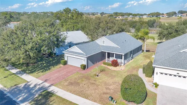 an aerial view of multiple houses with yard
