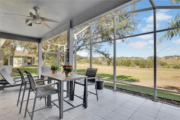 a view of a dining room with furniture large windows and wooden floor