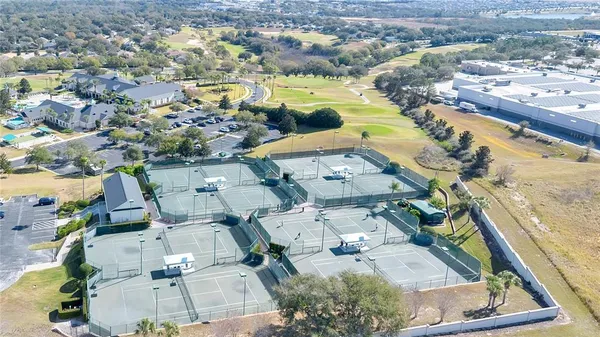 an aerial view of ocean and residential houses with outdoor space