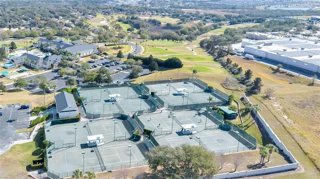 an aerial view of ocean and residential houses with outdoor space