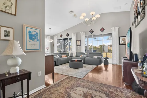 a living room with furniture a rug and white walls