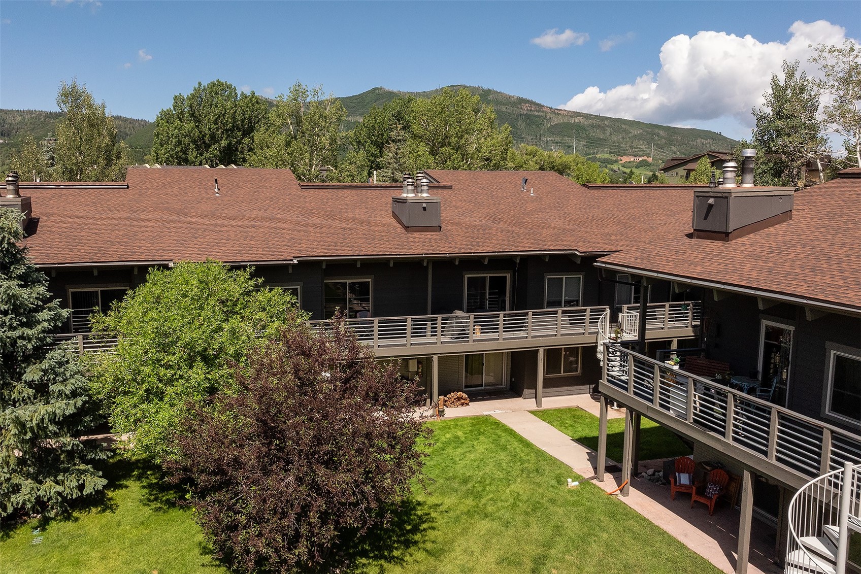 1355 Walton Creek Road, Unit 21 Steamboat Springs, CO 80487 - Photo 17 of 27 a front view of house with yard and trees in the background