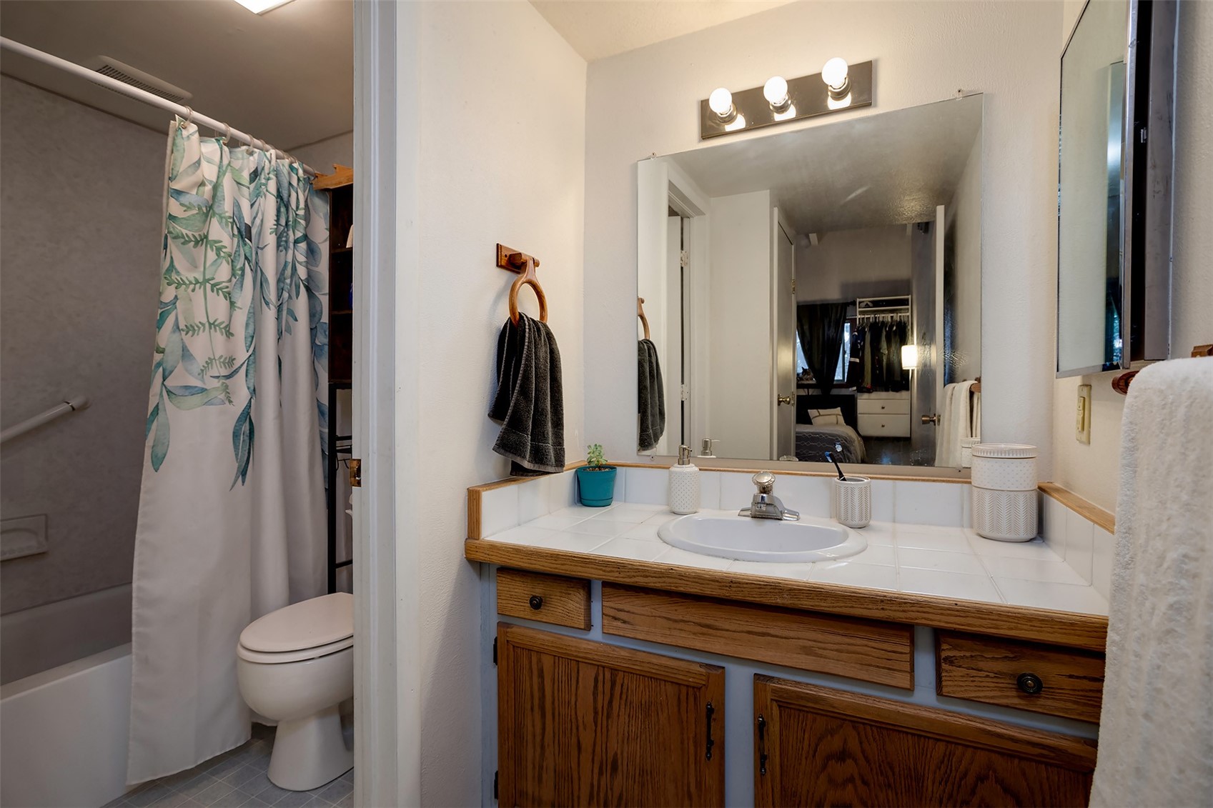 1355 Walton Creek Road, Unit 21 Steamboat Springs, CO 80487 - Photo 10 of 27 a bathroom with a granite countertop sink toilet and shower