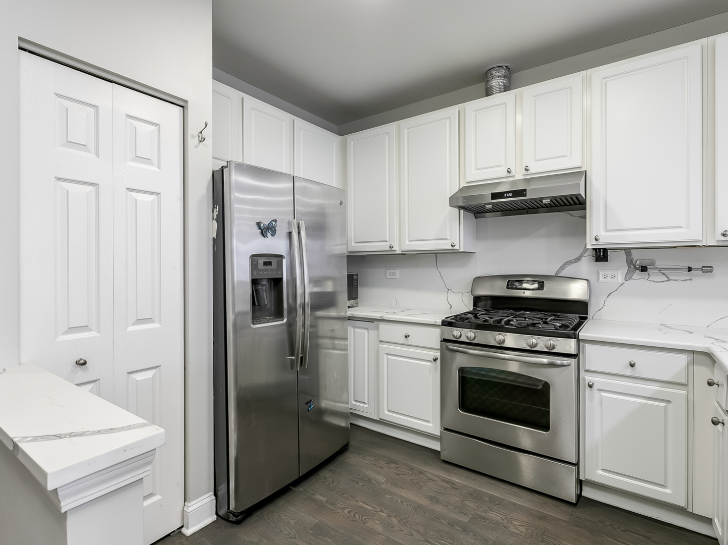 2331 Overlook Court Naperville, IL 60563 - Photo 7 of 27 a kitchen with stainless steel appliances white cabinets and a stove