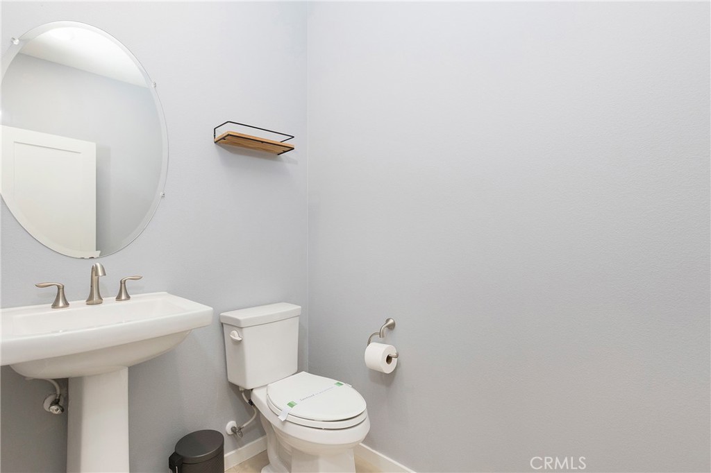 148 Acamar Irvine, CA 92618 - Photo 15 of 23 a bathroom with a toilet a sink and mirror