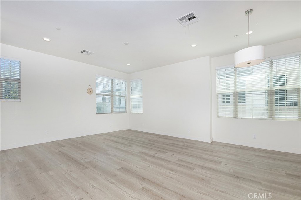 148 Acamar Irvine, CA 92618 - Photo 3 of 23 an empty room with wooden floor and windows