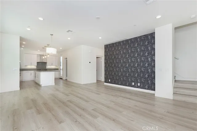 a view of kitchen with refrigerator and wooden floor