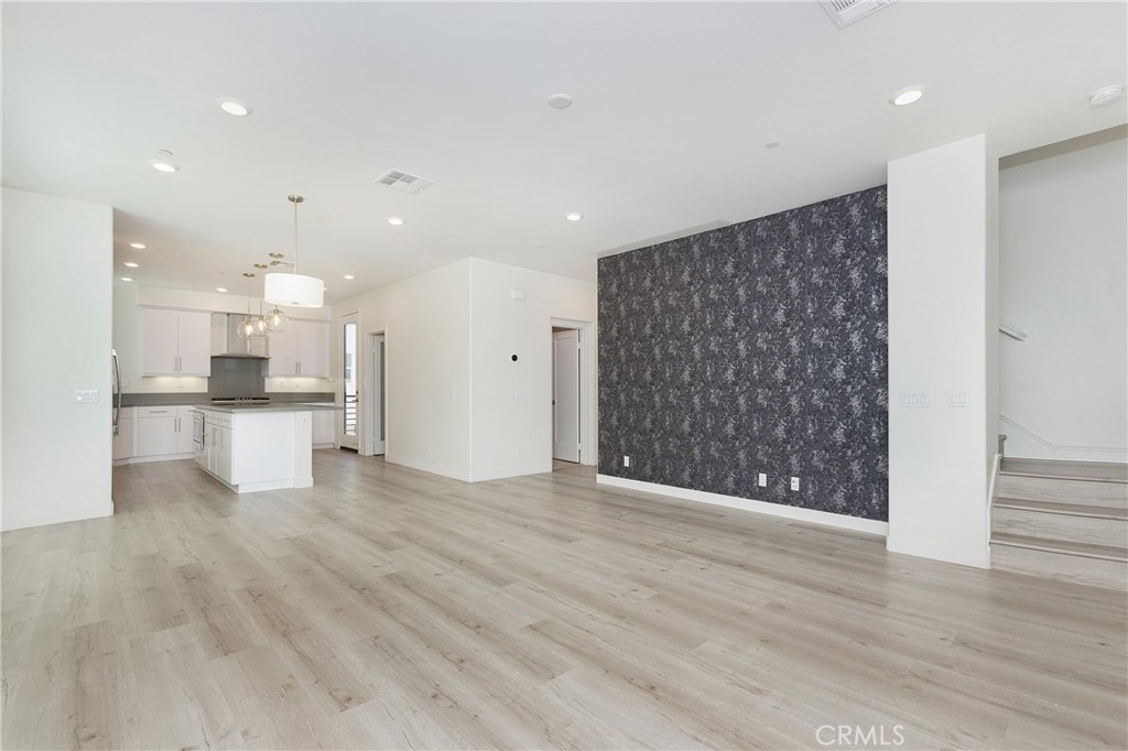 148 Acamar Irvine, CA 92618 - Photo 4 of 23 a view of kitchen with refrigerator and wooden floor