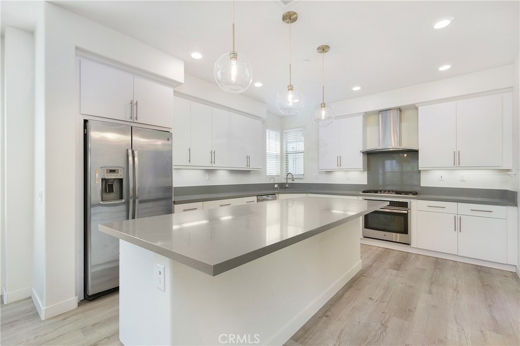 148 Acamar Irvine, CA 92618 - Photo 6 of 23 a large kitchen with granite countertop a large counter top stainless steel appliances and cabinets