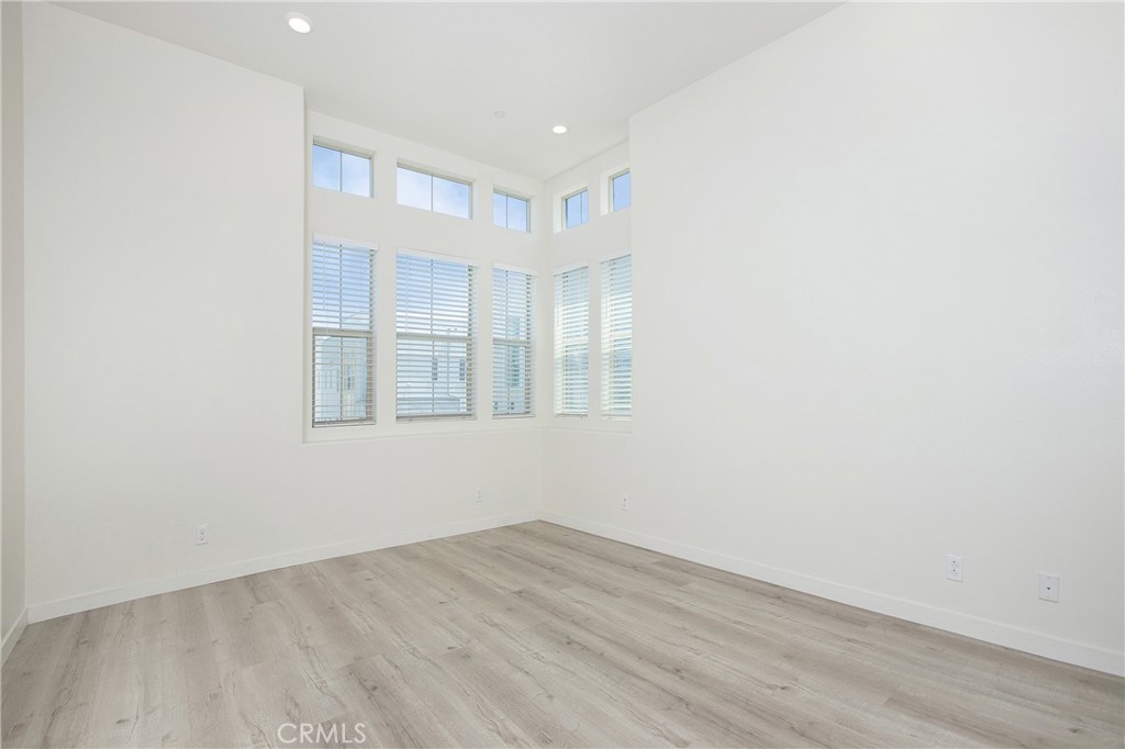 148 Acamar Irvine, CA 92618 - Photo 7 of 23 a view of an empty room with wooden floor and a window