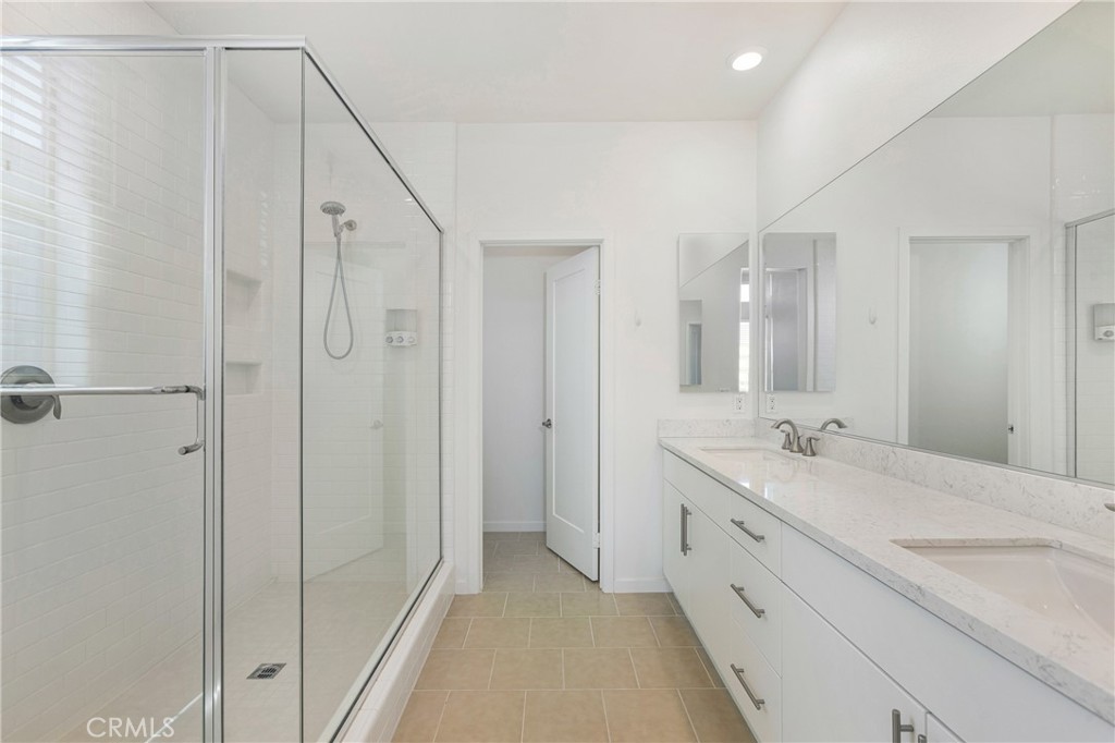 148 Acamar Irvine, CA 92618 - Photo 9 of 23 a spacious bathroom with a granite countertop sink a mirror and a shower