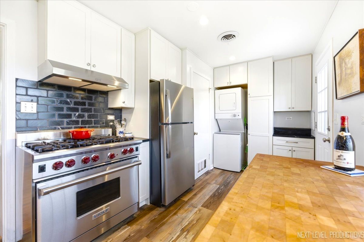 515 3rd Street Wilmette, IL 60091 - Photo 11 of 26 a kitchen with stainless steel appliances a stove a refrigerator and cabinets