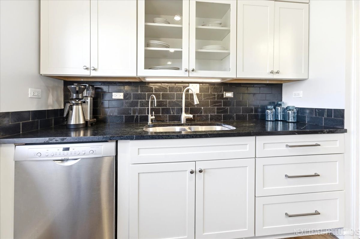 515 3rd Street Wilmette, IL 60091 - Photo 12 of 26 a kitchen with white cabinets and a window