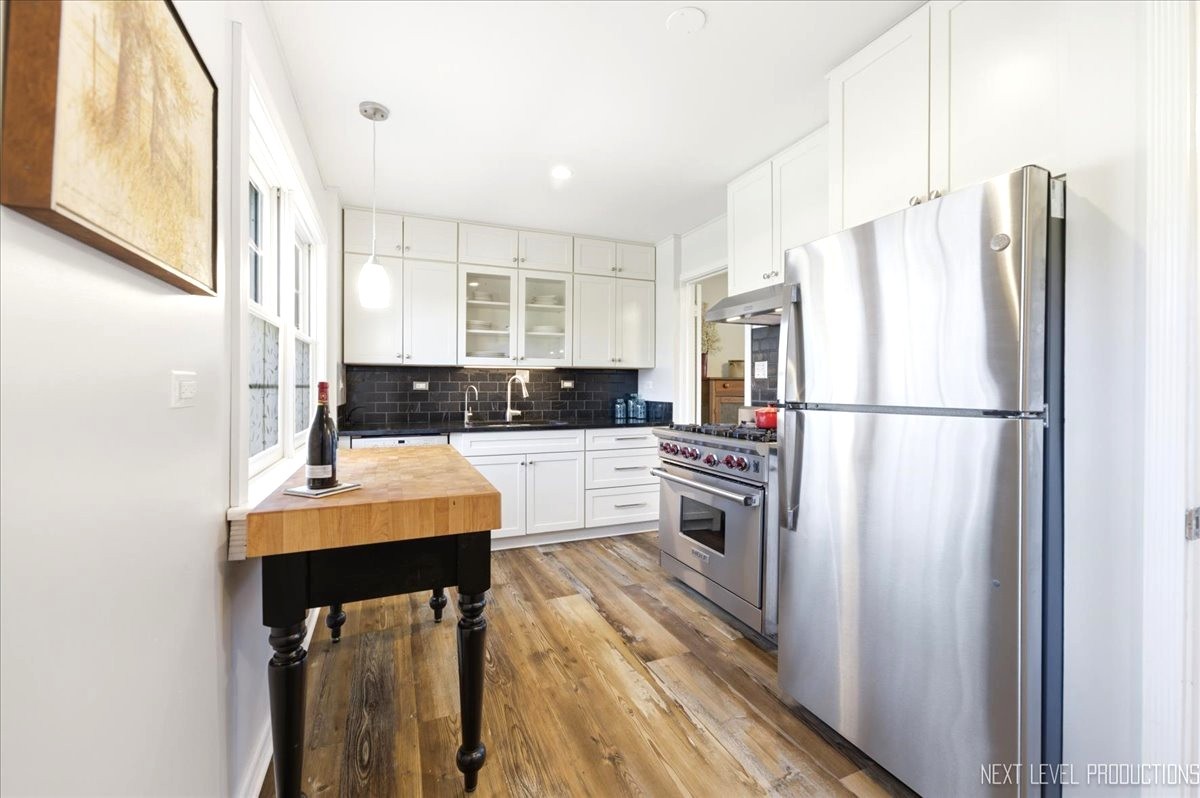 515 3rd Street Wilmette, IL 60091 - Photo 14 of 26 a kitchen with stainless steel appliances a refrigerator sink and cabinets